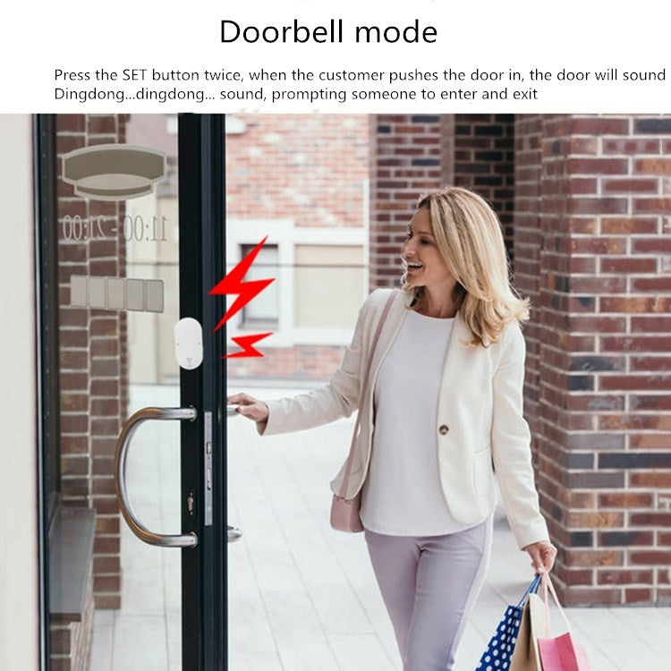 White doorbell-mode alarm sensor mounted on a glass door, with arrow icons