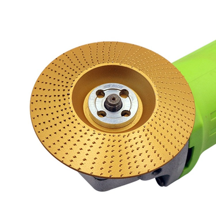 Gold angle-grinder grinding disk with center hub and abrasive surface, mounted on tool