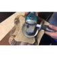 Silver sanding grinding disk in use on wood with angle grinder attached