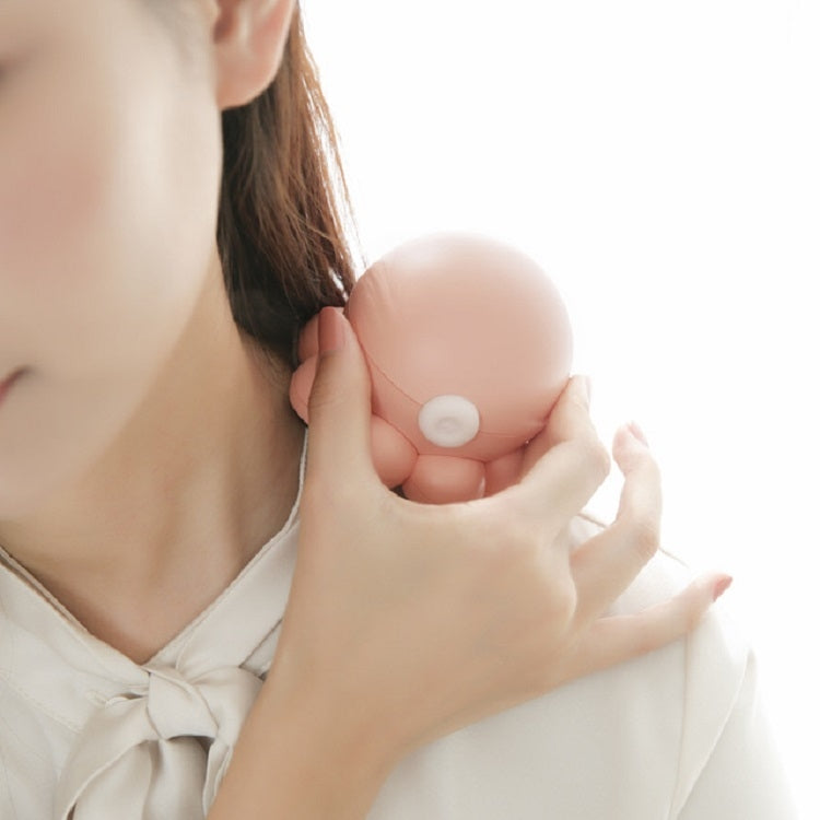 Pink octopus neck massager held against the collarbone area on a person