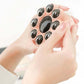 Pink octopus massager underside with multiple black rolling nodes for massage