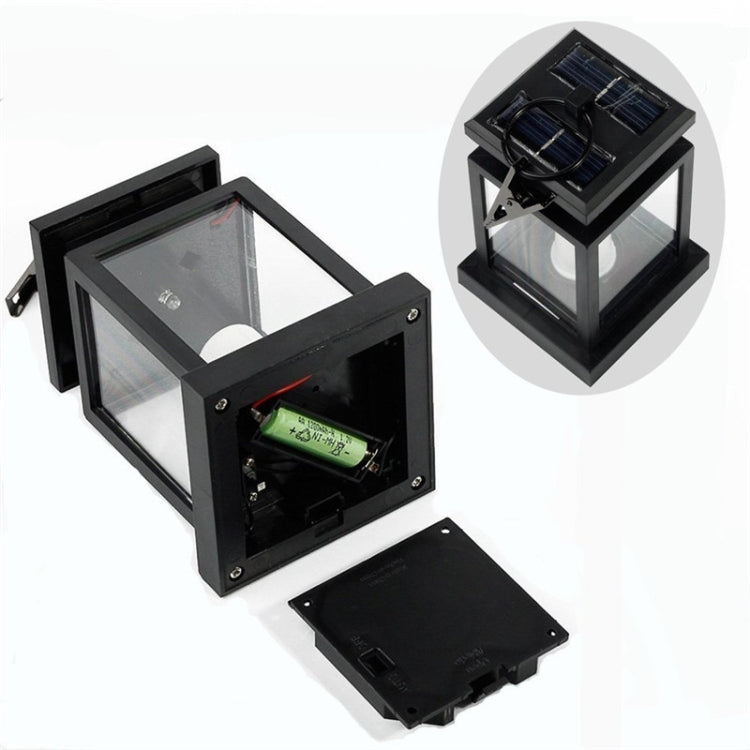 Black lantern-style LED candle light with open solar panel and visible battery compartment