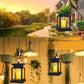 Hanging black lantern-style LED candle light with warm glowing flame in clear panels