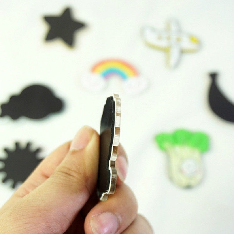 Thin magnetic strip on cartoon refrigerator magnet held in a hand