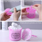 Pink facial cleaner frother bottle with squeeze handle and foam cup, lid shown