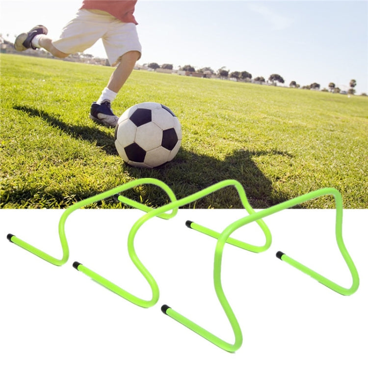 Football training hurdle on grass with neon green frame and black end caps
