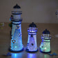 Three decorative LED night light towers with dark caps and blue perforated glow on table