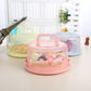 Pink round-handle plastic storage/cake box with domed lid, showing interior contents.