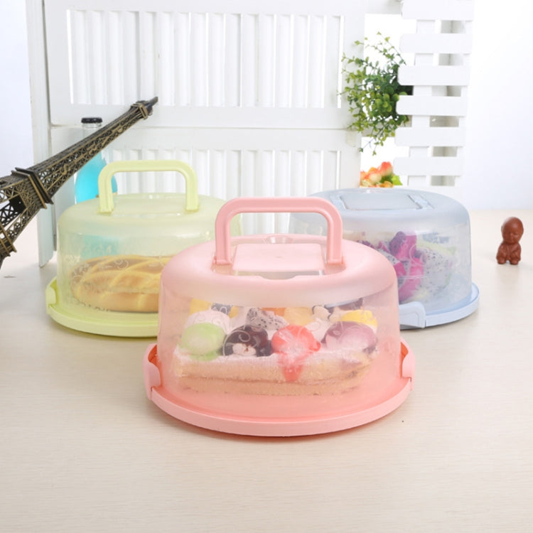 Pink round-handle plastic storage/cake box with domed lid, showing interior contents.