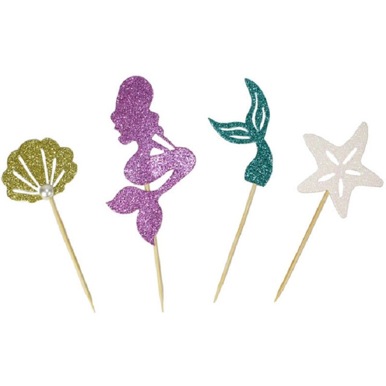 Mermaid cupcake toppers close-up: purple figure, gold fan, teal tail, white star on sticks