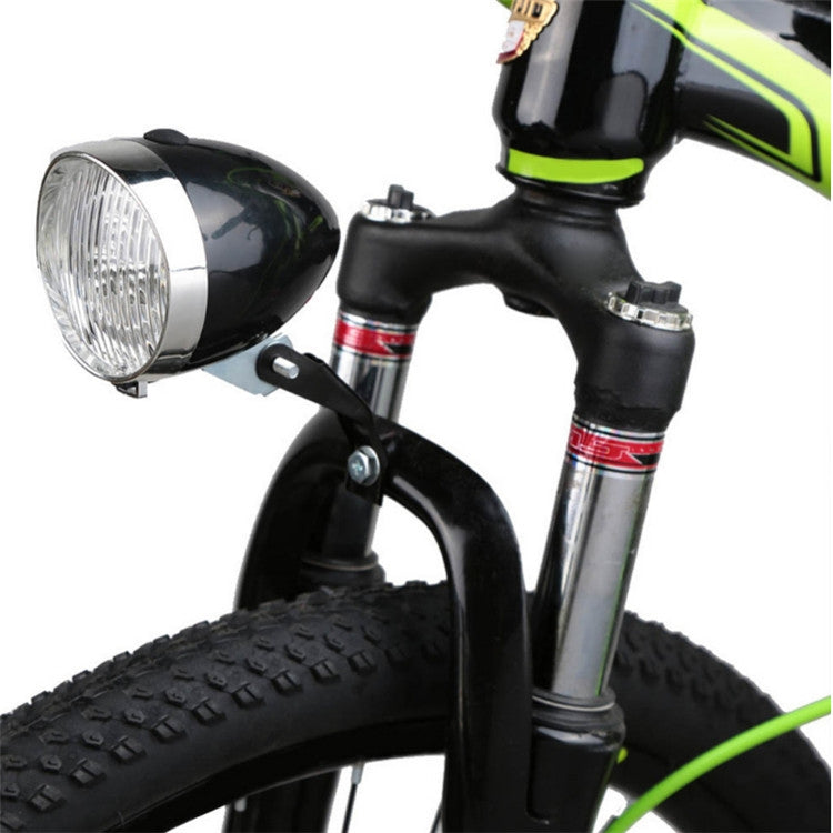 Black retro bicycle LED headlight mounted on the bike front