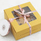Yellow gift box with clear window, tied pink "Handmade" ribbon