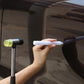 Hand holding white pointed dent repair leveling pen tool