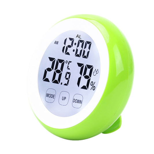 Green indoor electronic thermometer with white face and black digits for time, temperature, humidity.