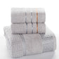 Stacked gray cotton bath towel set with blue stripe bands and Greek key border