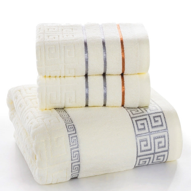 Cream cotton bath towel set with blue and orange stripe bands and Greek key corner trim