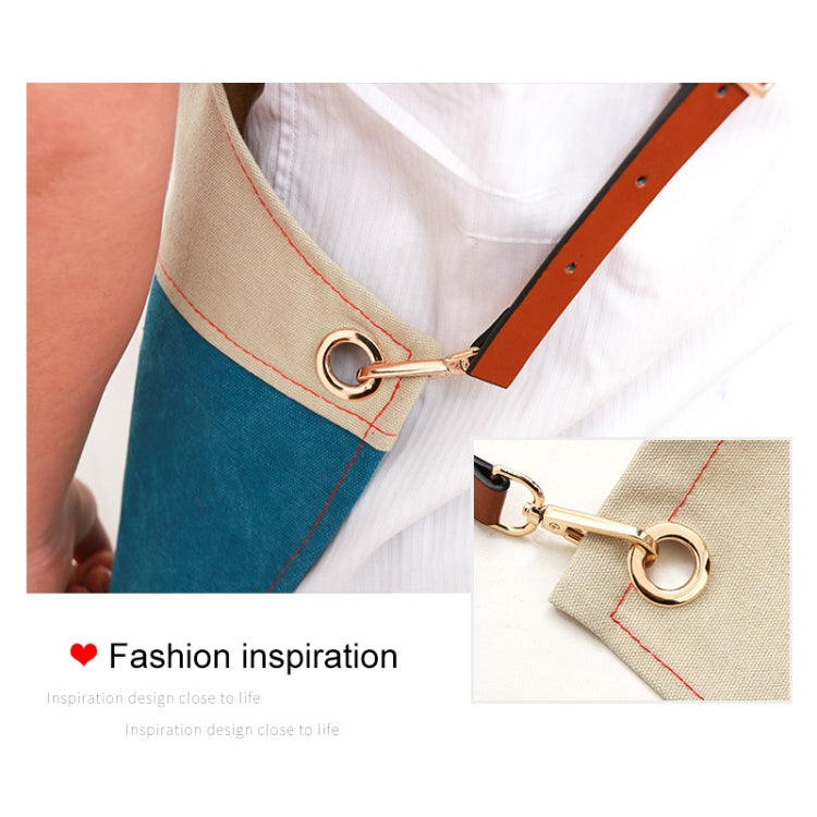 Blue denim apron strap detail with metal ring and adjustable brown leather buckle