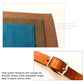 Denim apron corner and hardware view with brown fabric trim and orange-red stitching
