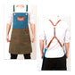 Two-tone denim apron worn with adjustable cross-back straps and front pocket