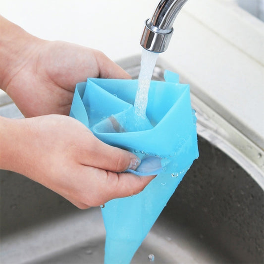 Silicone icing piping bag, blue, squeezed to dispense icing