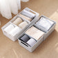 Two-piece open sock organizer with dividers; gray and white socks visible