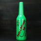 Green plastic squeeze bottle with ribbed cap and printed bartending label.