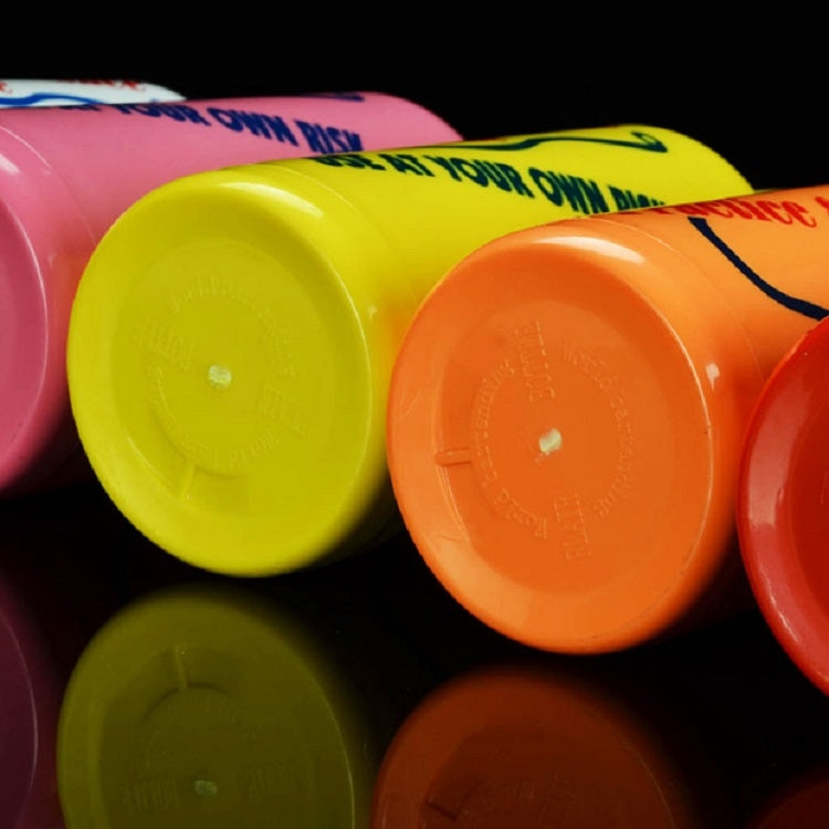 Plastic squeeze bottle caps close-up in yellow, orange, pink, and green.