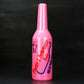 Pink plastic squeeze bottle with ribbed cap and printed bartending label.