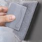 Close-up of gray window groove cleaning brush with plastic scraper and scrub pad