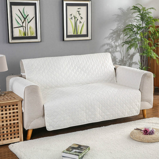 Reversible quilted sofa cover with anti-slip backing, light beige, recliner fit.