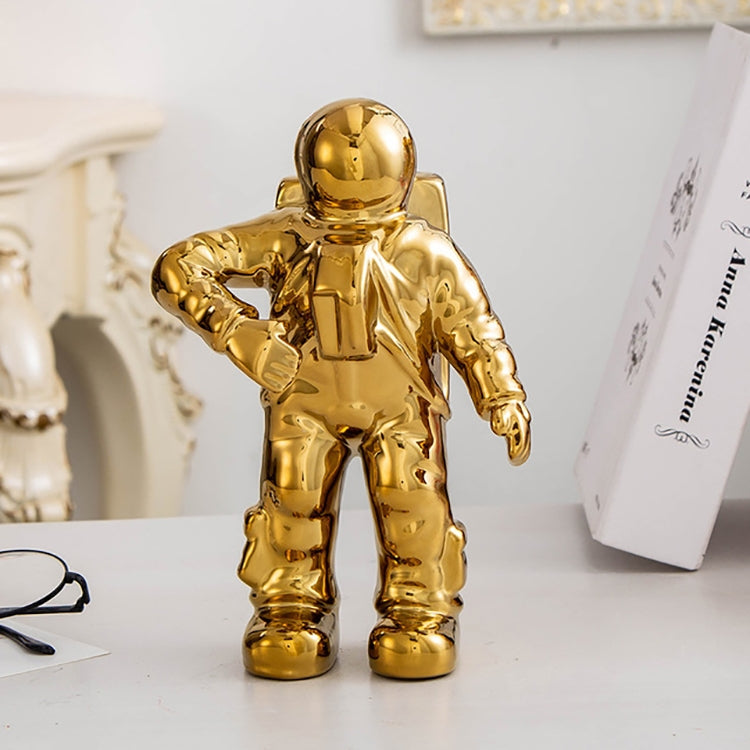 Gold astronaut ceramic vase figurine, standing with one arm extended