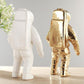 White and gold astronaut ceramic vase figurines, side-by-side full-body