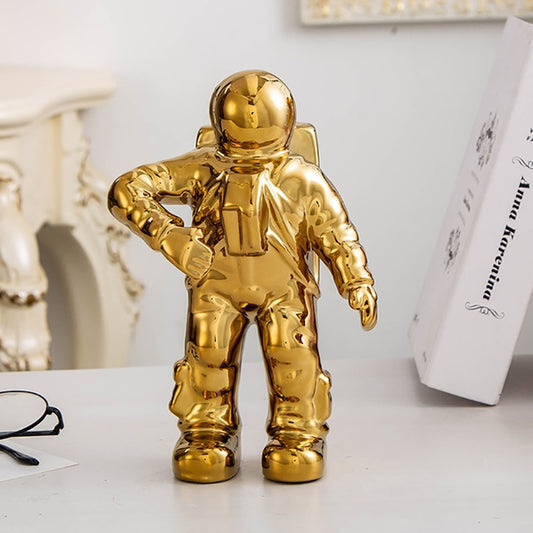 Gold astronaut ceramic vase figurine, standing with one arm extended