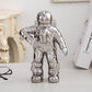 Silver astronaut ceramic vase figurine, standing with one arm extended