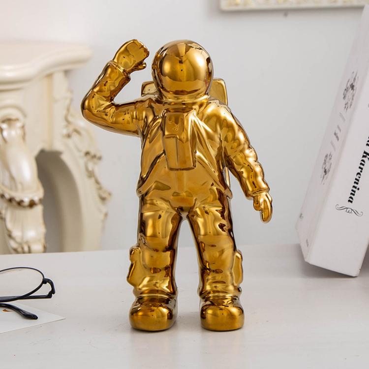 Gold astronaut ceramic vase figurine, salute pose with raised right arm
