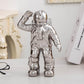 Silver astronaut ceramic vase figurine with raised salute hand for dried flowers