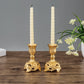Gold two candle holders with tall fluted stands and carved pedestal bases