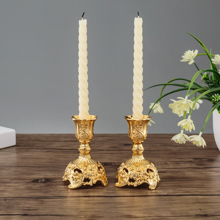 Gold two candle holders with tall fluted stands and carved pedestal bases