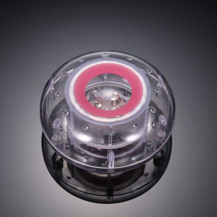 Floating LED pool lamp with clear housing and pink inner light ring