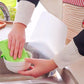 White splash-proof baffle board between hands and sink area during cleaning.