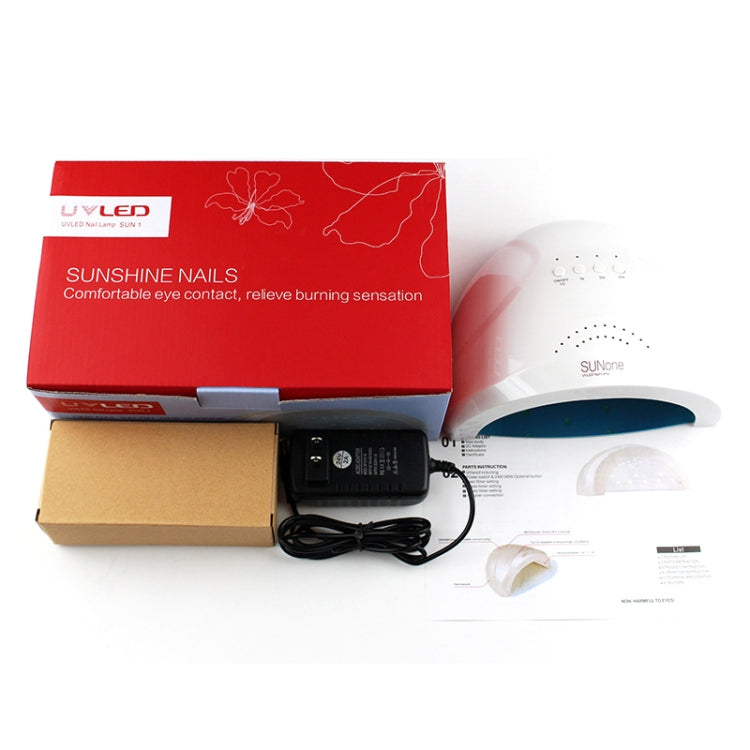 UV nail lamp kit with white dryer, power adapter, cables, and instruction papers