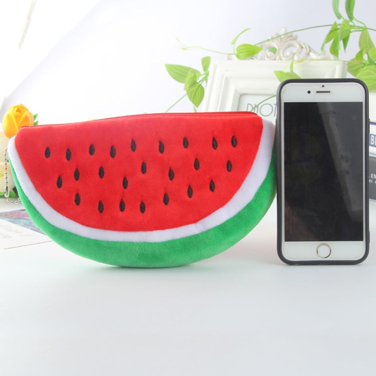 Red watermelon plush pencil bag with zipper, next to smartphone on a table