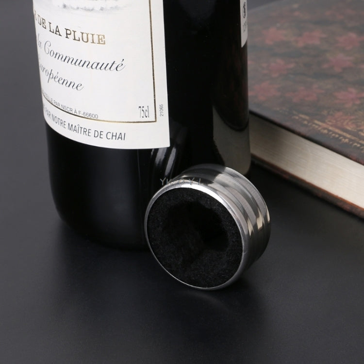 Stainless steel wine stop ring on wine bottle neck, close-up