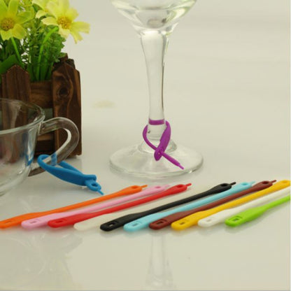 Silicone wine glass marker set with purple marker and colorful markers on tray