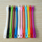 Colorful silicone wine glass markers arranged on a tray in a neat row
