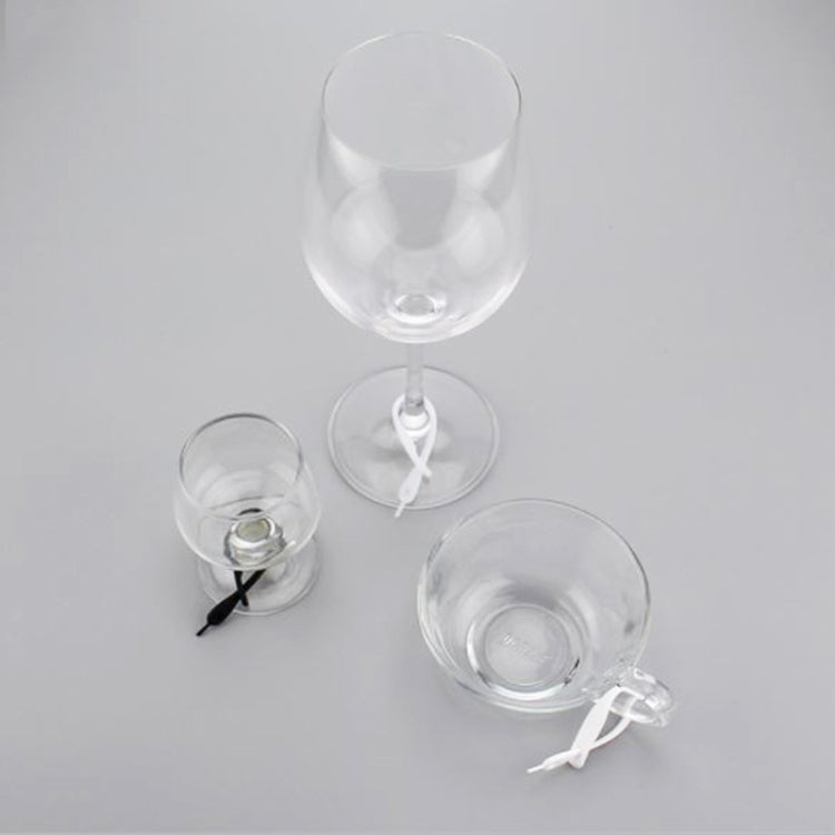 Silicone wine glass markers on three stemmed glasses with colored loop accents