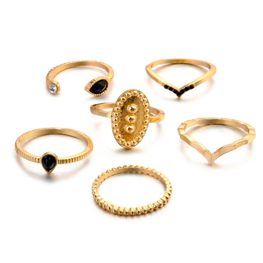 Gold-tone waterdrop ring set, six stacked bands with black stones and clear accents