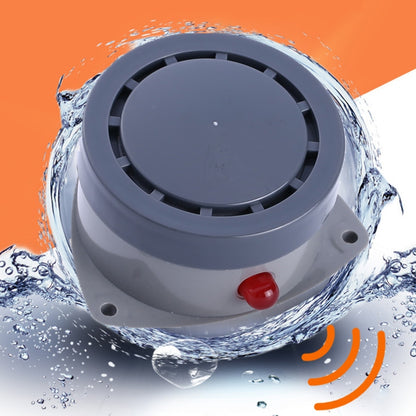 Water leak alarm detector with circular speaker grille and red alert button, gray body