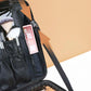 Black zippered manicure tool bag with hanging pouches and adjustable shoulder strap