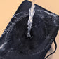 Black makeup organizer bag with textured inner lining and carrying strap
